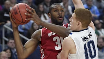 Mar 18, 2017; Buffalo, NY, USA; Wisconsin Badgers forward Vitto Brown (30) looks to pass against Villanova Wildcats guard Donte DiVincenzo (10) in the first half during the second round of the 2017 NCAA Tournament at KeyBank Center. Mandatory Credit: Mark Konezny-Imagn Images