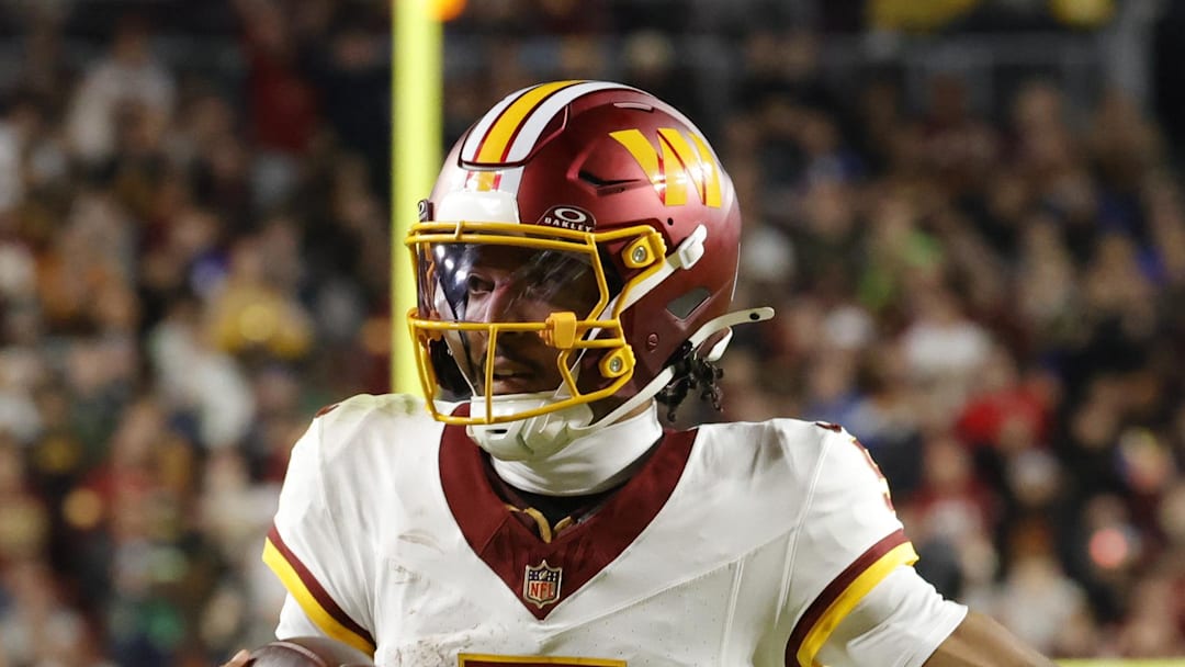 Washington Commanders quarterback Jayden Daniels runs the ball against the Seattle Seahawks.