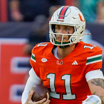 Nov 8, 2025; Miami Gardens, Florida, USA; Miami Hurricanes quarterback Carson Beck (11) rushes the ball against the Syracuse Orange during the first quarter at Hard Rock Stadium. Mandatory Credit: Jeff Romance-Imagn Images