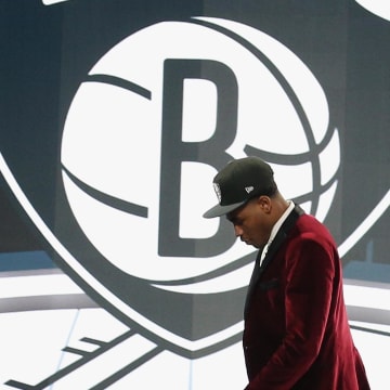 Jul 29, 2021; Brooklyn, New York, USA; Cameron Thomas (LSU) walks off the stage after being selected as the number twenty-seven overall pick by the Brooklyn Nets in the first round of the 2021 NBA Draft at Barclays Center. Mandatory Credit: Brad Penner-USA TODAY Sports
