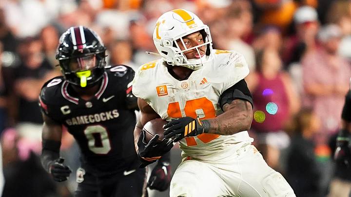 Tennessee running back DeSean Bishop (18) escapes tackles as he runs with the ball during a college football game between Tennessee and South Carolina at Williams-Brice Stadium in Columbia, S.C., on Oct. 24, 2026.