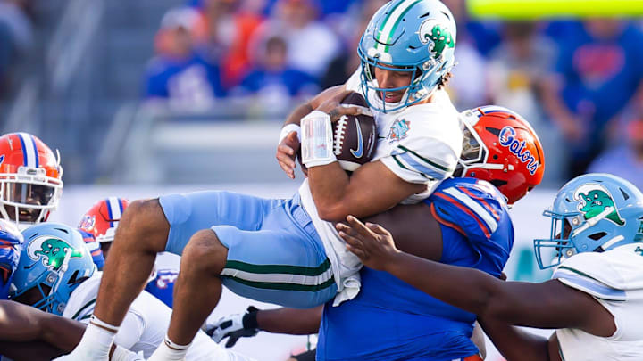 Florida Gators defensive lineman Desmond Watson (21) tackles Tulane Green Wave quarterback Ty Thompson (7) during the first half at Raymond James Stadium in Tampa, FL on Friday, December 20, 2024 in the 2024 Union Home Mortgage Gasparilla Bowl. [Doug Engle/Gainesville Sun]