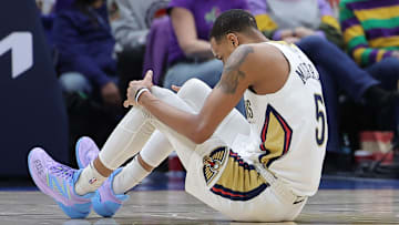 Dejounte Murray #5 of the New Orleans Pelicans injures himself against the Boston Celtics.