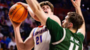 Milos Ilic (right, green uniform) defends in a game against Florida in 2023