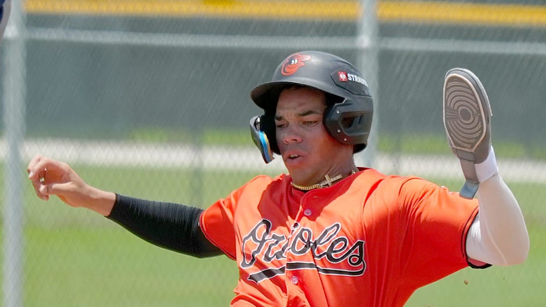 Safely sliding into home plate is Orioles' Jordan Sanchez (#32). The Florida Complex League, minor league team Baltimore Orioles plays at the Buck O'Neil Complex baseball field located at Twin Lakes Park in east Sarasota.