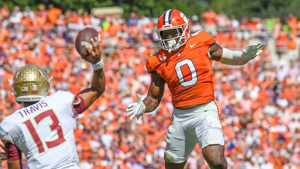 Clemson Tigers linebacker Barrett Carter goes airborne on a defensive play during a college football game in the ACC.