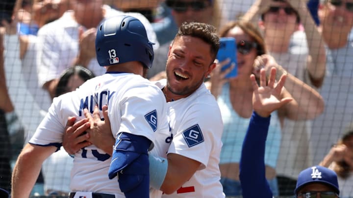Dodgers third baseman Max Muncy (13) celebrates with shortstop Miguel Rojas (72) after hitting a grand slam during the sixth inning against the Washington Nationals at Dodger Stadium on June 22. Dodgers third baseman Max Muncy (13) celebrates with shortstop Miguel Rojas (72) after hitting a grand slam during the sixth inning against the Washington Nationals at Dodger Stadium on June 22.