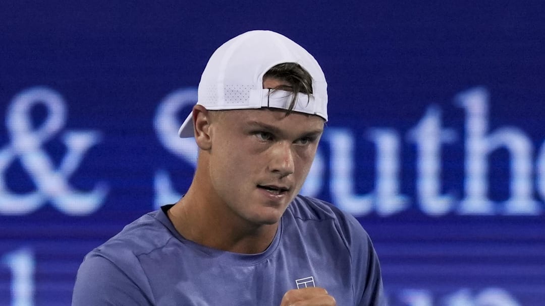 Holger Rune reacts after returning a shot