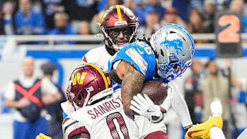 Detroit Lions running back Jahmyr Gibbs (26) runs for a touchdown against Washington Commanders cornerback Mike Sainristil (0) during the second half of the NFC divisional round at Ford Field in Detroit on Saturday, Jan. 18, 2025.