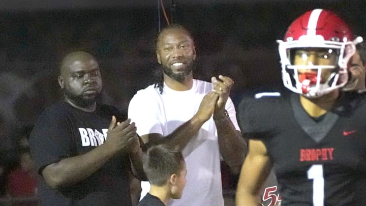 Sep 6, 2024; Phoenix, Ariz., U.S.; Former Arizona Cardinal wide receiver Larry Fitzgerald cheers for his son after Brophy Prep's Devin Fitzgerald (1) scores a touchdown during a game against Regis Jesuit at Central HS football field. Mandatory Credit: Cheryl Evans-Arizona Republic Sep 6, 2024; Phoenix, Ariz., U.S.; Former Arizona Cardinal wide receiver Larry Fitzgerald cheers for his son after Brophy Prep's Devin Fitzgerald (1) scores a touchdown during a game against Regis Jesuit at Central HS football field. Mandatory Credit: Cheryl Evans-Arizona Republic