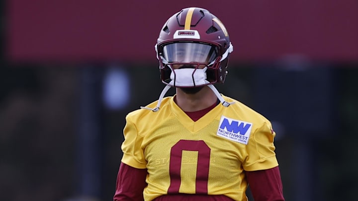 Jul 26, 2024; Ashburn, VA, USA; Washington Commanders quarterback Marcus Mariota (0) stands on the field during warmup before day three of training camp at Commanders Park. Mandatory Credit: Geoff Burke-Imagn Images