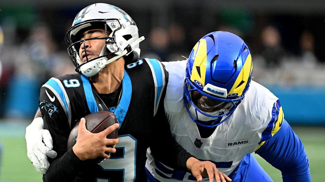 Jan 10, 2026; Charlotte, NC, USA; Los Angeles Rams defensive tackle Poona Ford (95) sacks Carolina Panthers quarterback Bryce Young (9) in the first half during the NFC Wild Card Round game at Bank of America Stadium. 