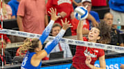 Nebraska opposite hitter Virginia Adriano attacks against Creighton outside hitter Ava Martin.