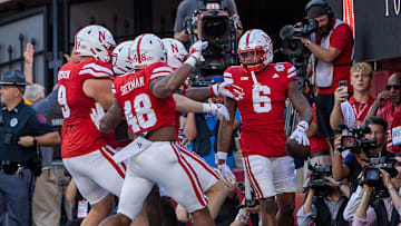 Nebraska defenders prepare to celebrate with defensive back Tommi Hill after his pick six on Colorado's Shedeur Sanders.