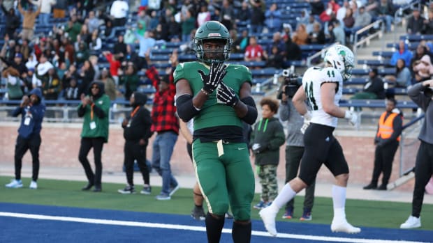 Deondrae Riden points to his ring finger after a TD in DeSoto's Texas 6A Division II semifinal win over Southlake Carroll.