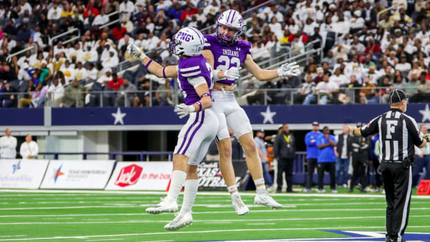 Port Neches-Groves teammates celebrate during the 5A Division II state championship win over South Oak Cliff in Dec. 2023.