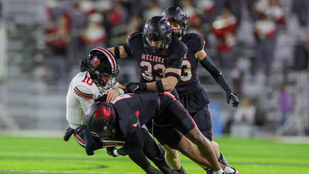 Melissa defenders swarm Lovejoy's quarterback during a district showdown on Nov. 3, 2023.