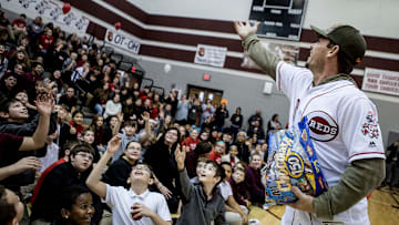 Scooter Gennett, second baseman for the Cincinnati Reds, throws candy to students at Heritage Middle School, Friday January 18, during an assembly at the school. Gennett and other Reds players were on a caravan tour visiting schools. The players answered questions from students while Mr. Red the team mascot entertained the crowd. 

Reds At Heritage 02