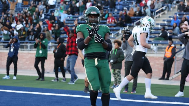 Deondrae Riden points to his ring finger after a TD in DeSoto's Texas 6A Division II semifinal win over Southlake Carroll.