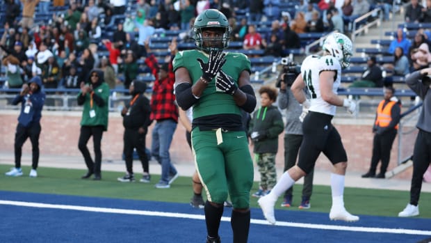 Deondrae Riden points to his ring finger after a TD in DeSoto's Texas 6A Division II semifinal win over Southlake Carroll.