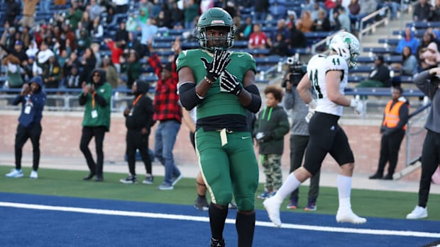 Deondrae Riden points to his ring finger after a TD in DeSoto's Texas 6A Division II semifinal win over Southlake Carroll.