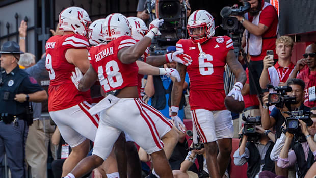 Nebraska defenders prepare to celebrate with defensive back Tommi Hill after his pick six on Colorado's Shedeur Sanders.