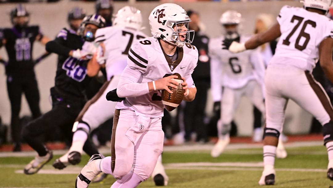 Mount Carmel QB Jack Elliott surveys the Downers Grove North defense in an Illinois high school football game in 2023.