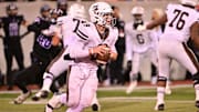 Mount Carmel QB Jack Elliott surveys the Downers Grove North defense in an Illinois high school football game in 2023.
