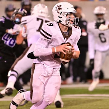 Mount Carmel QB Jack Elliott surveys the Downers Grove North defense in an Illinois high school football game in 2023.