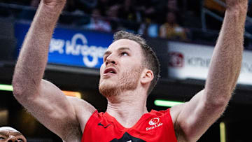 Toronto Raptors center Jakob Poeltl shoots the ball while Indiana Pacers center Myles Turner defends.