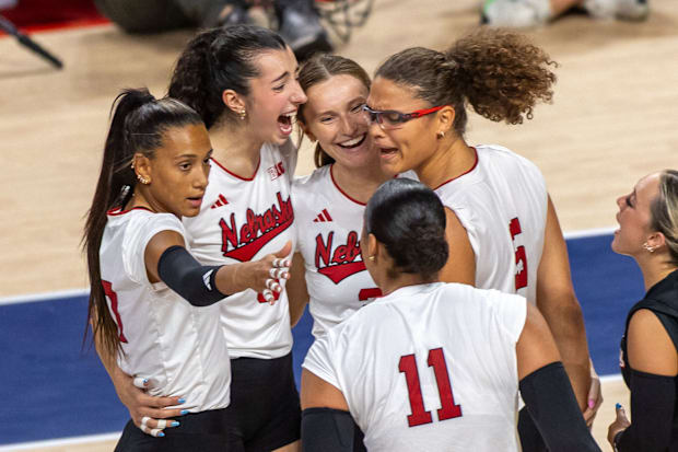 Members of the Husker Volleyball team celebrate after a Rebekah Allick kill.
