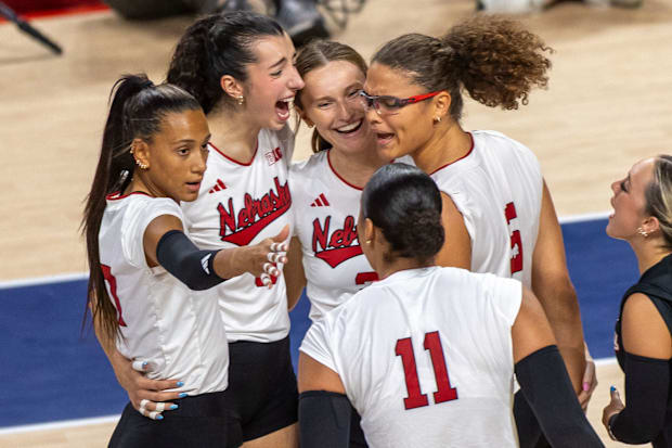 Members of the Husker Volleyball team celebrate after a Rebekah Allick kill.