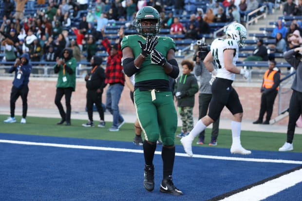 Deondrae Riden points to his ring finger after a TD in DeSoto's Texas 6A Division II semifinal win over Southlake Carroll.