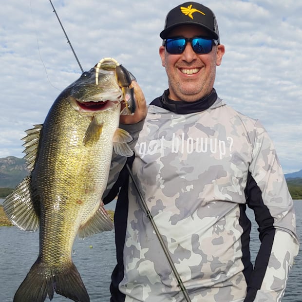 the author holding up a big el salto bass caught on a SPRO Rat lure.