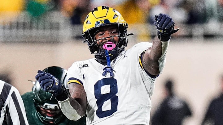 Michigan edge Derrick Moore (8) celebrates a sack against Michigan State quarterback Alessio Milivojevic (11) during the second half at Spartan Stadium in East Lansing on Saturday, October 25, 2025.