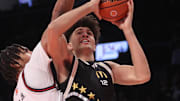 Apr 1, 2025; Brooklyn, NY, USA; McDonald's All American East forward Cameron Boozer (12) shoots the ball against McDonald's All American West center Chris Cenac Jr. (1) during the second half of the game at Barclays Center. Mandatory Credit: Pamela Smith-Imagn Images