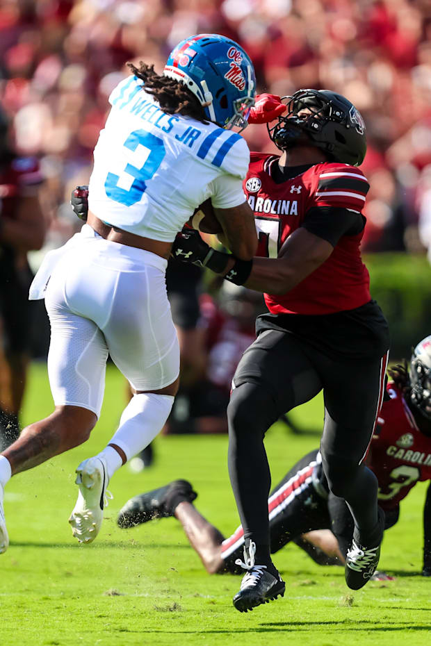 Mississippi Rebels WR Antwane Wells Jr. holds the face mask of South Carolina Gamecocks DB Nick Emmanwori.