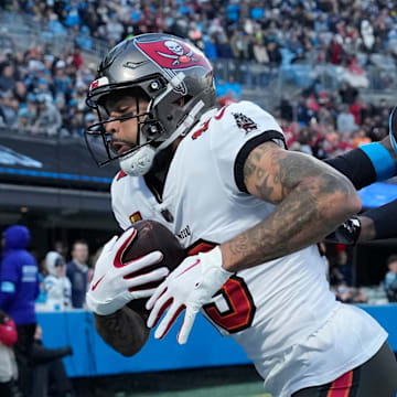 Dec 1, 2024; Charlotte, North Carolina, USA; Tampa Bay Buccaneers wide receiver Mike Evans (13) catches a touchdown as Carolina Panthers cornerback Jaycee Horn (8) defends in the first quarter at Bank of America Stadium. 