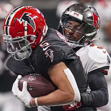 Oct 3, 2024; Atlanta, Georgia, USA; Atlanta Falcons wide receiver Drake London (5) is tackled by Tampa Bay Buccaneers safety Jordan Whitehead (3) after a catch at Mercedes-Benz Stadium. Mandatory Credit: Dale Zanine-Imagn Images