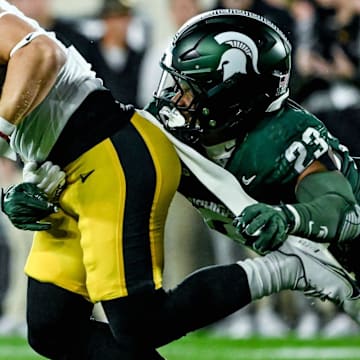 Michigan State's Darius Snow, right, tackles Iowa's Kaden Wetjen in the first quarter on Saturday, Oct. 19, 2024, at Spartan Stadium in East Lansing.