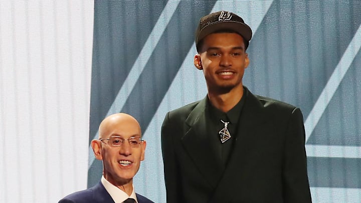 Jun 22, 2023; Brooklyn, NY, USA; Victor Wembanyama poses for photos with NBA commissioner Adam Silver after being selected first by the San Antonio Spurs in the first round of the 2023 NBA Draft at Barclays Arena. 