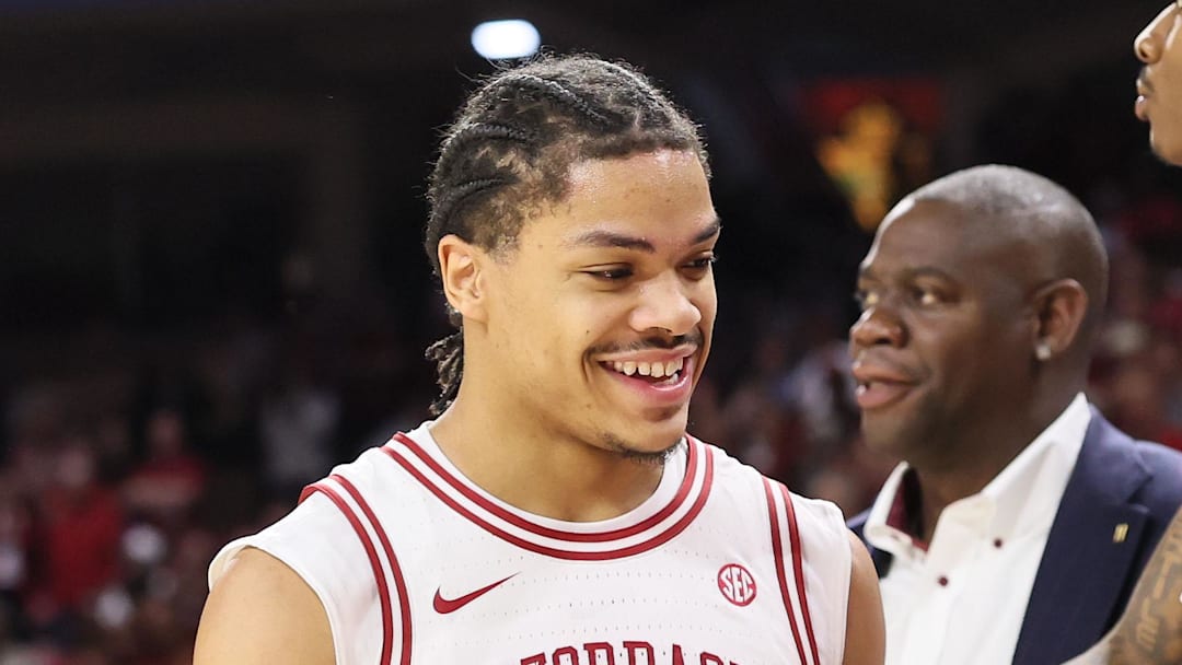 Arkansas Razorbacks guard Darius Acuff Jr. celebrates with the bench after coming out of the game in he final minute of the Hogs' 99-84 victory against theTexas A&M Aggies at Bud Walton Arena. 