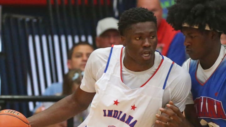 Indiana Senior All-Star Flory Bidunga (1) is guarded by Indiana Junior All-Star Dezmon Briscoe (32) during the Indiana Boys Junior-Senior All-Star Game, Wednesday, June 5, 2024, at Kokomo Memorial Gym in Kokomo, Ind.