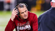 Nov 16, 2024; Columbia, South Carolina, USA; South Carolina Gamecocks head coach Shane Beamer checks on an injured player against the Missouri Tigers in the second quarter at Williams-Brice Stadium. Mandatory Credit: Jeff Blake-Imagn Images