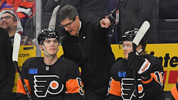 Mar 27, 2025; Philadelphia, Pennsylvania, USA; Philadelphia Flyers interim head coach Brad Shaw talks with defenseman Egor Zamula (5) against the Montreal Canadiens during the second period at Wells Fargo Center. 