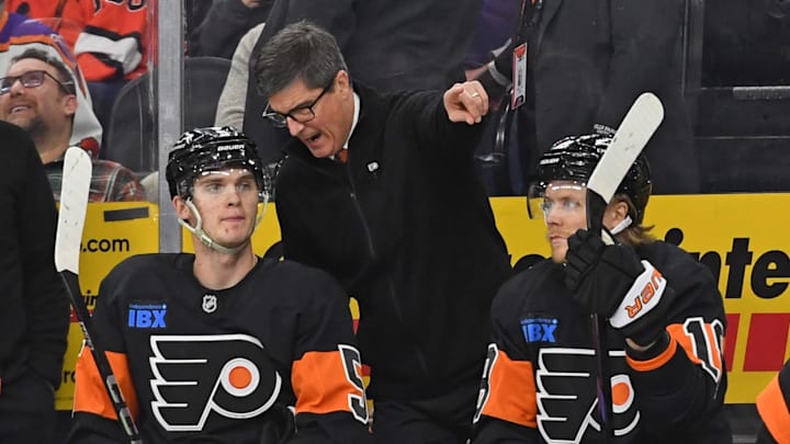 Mar 27, 2025; Philadelphia, Pennsylvania, USA; Philadelphia Flyers interim head coach Brad Shaw talks with defenseman Egor Zamula (5) against the Montreal Canadiens during the second period at Wells Fargo Center. 