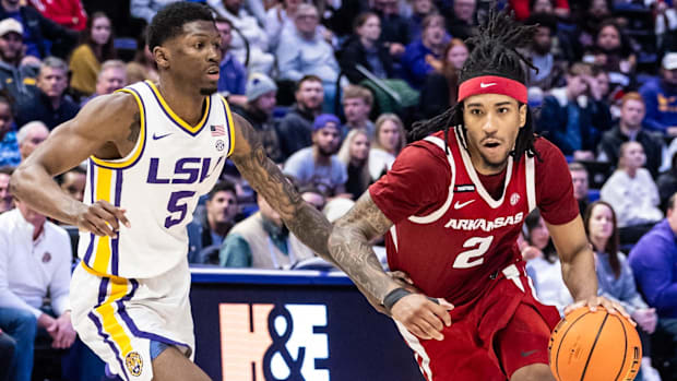 Razorbacks guard Boogie Fland (2) drives against LSU guard Cam Carter (5) during the second half at Pete Mara