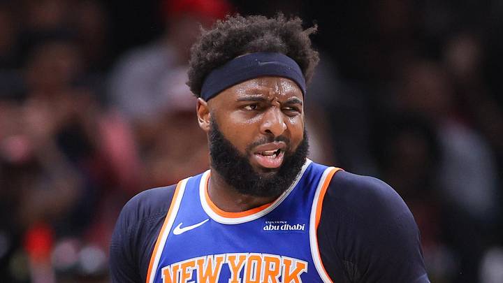 Apr 30, 2026; Atlanta, Georgia, USA; New York Knicks center Mitchell Robinson (23) is restrained by assistant coach Rick Brunson against the Atlanta Hawks in the second quarter during game six of the first round of the 2026 NBA Playoffs at State Farm Arena. Mandatory Credit: Brett Davis-Imagn Images