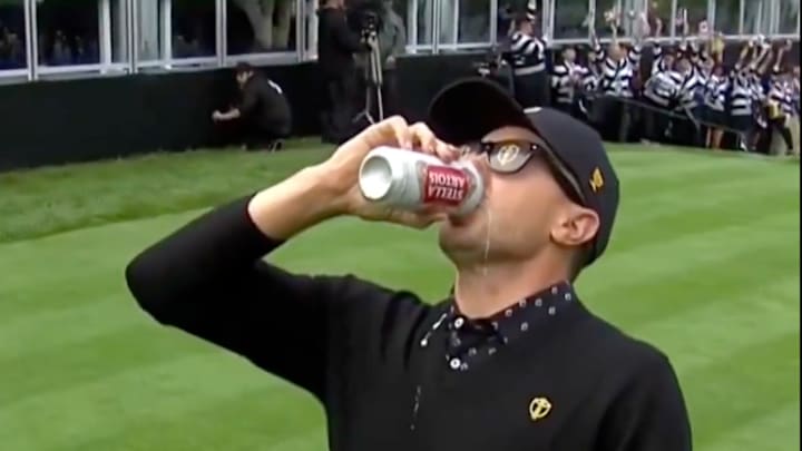 Mackenzie Hughes chugs a beer ahead of the 2024 Presidents Cup. Mackenzie Hughes chugs a beer ahead of the 2024 Presidents Cup.
