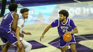 Noah Reynolds dribbles off an Ernest Udeh Jr. screen for TCU men's basketball against Kansas on January 22, 2025.